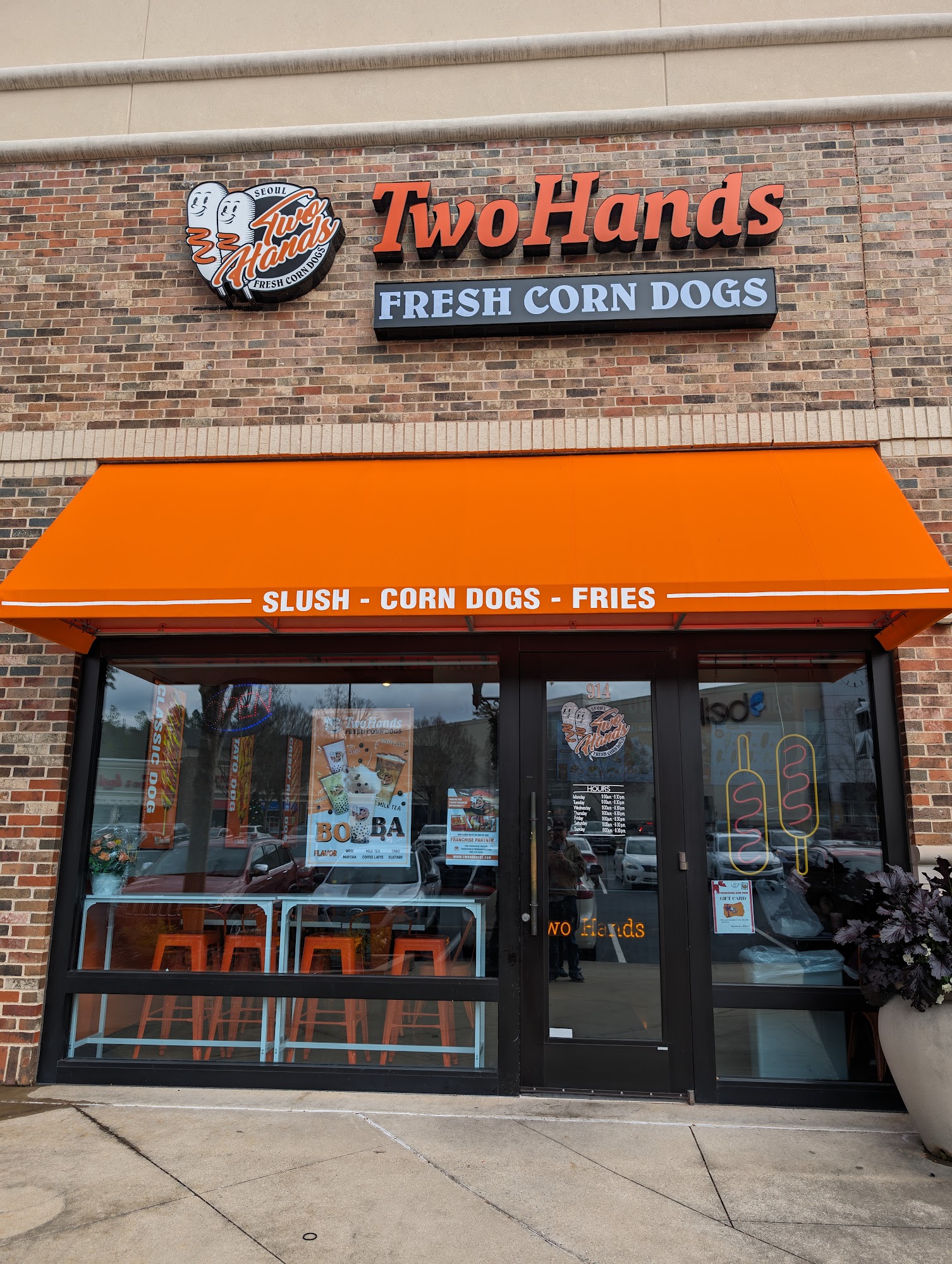 Two hands corn dogs